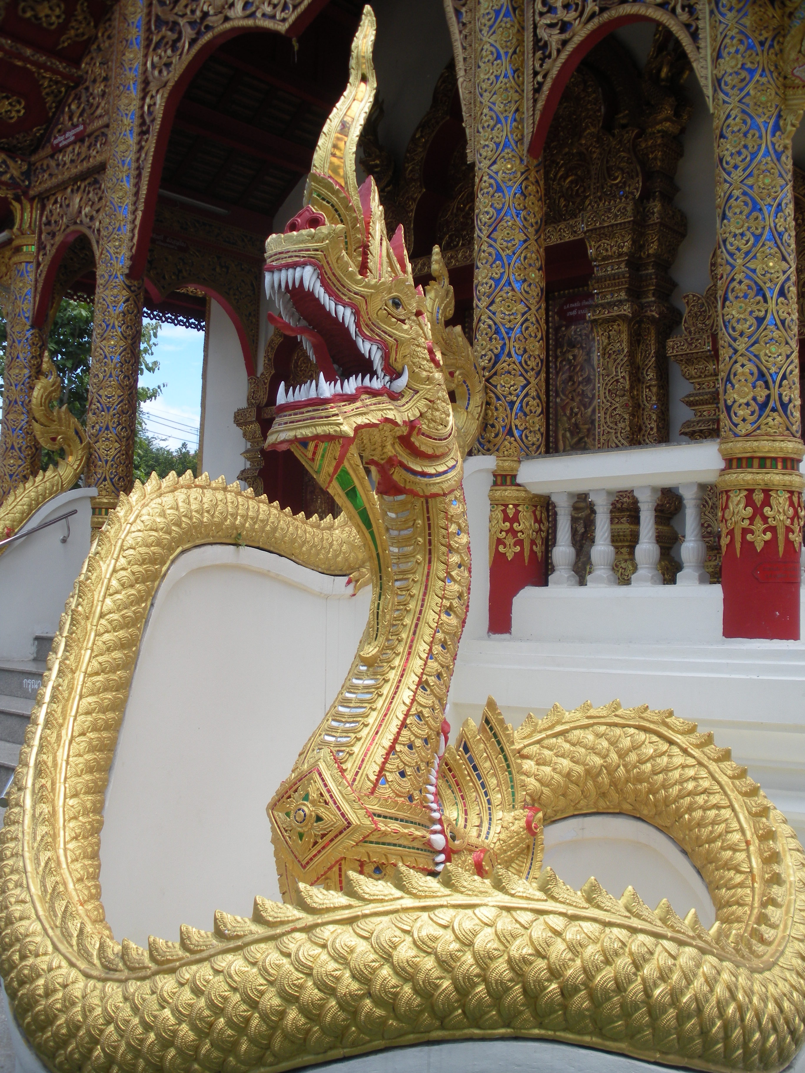 a golden naga, or serpent, guarding a temple